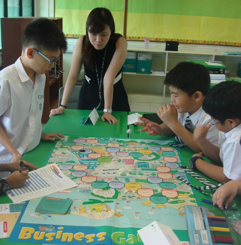 Teacher with students playing board game